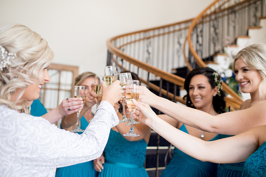 bridesmaids and bride have a champagne toast 
