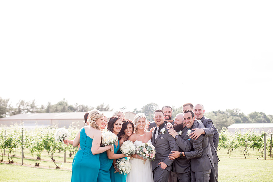 wedding portraits with the wedding party in the vineyards at tomasello winery