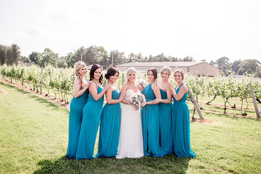 bride with her bridesmaids in aqua floor length dresses
