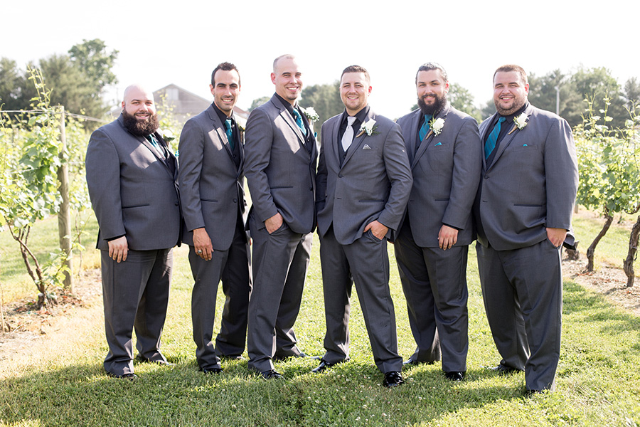 groom and his groomsmen in gray suits and black shirts