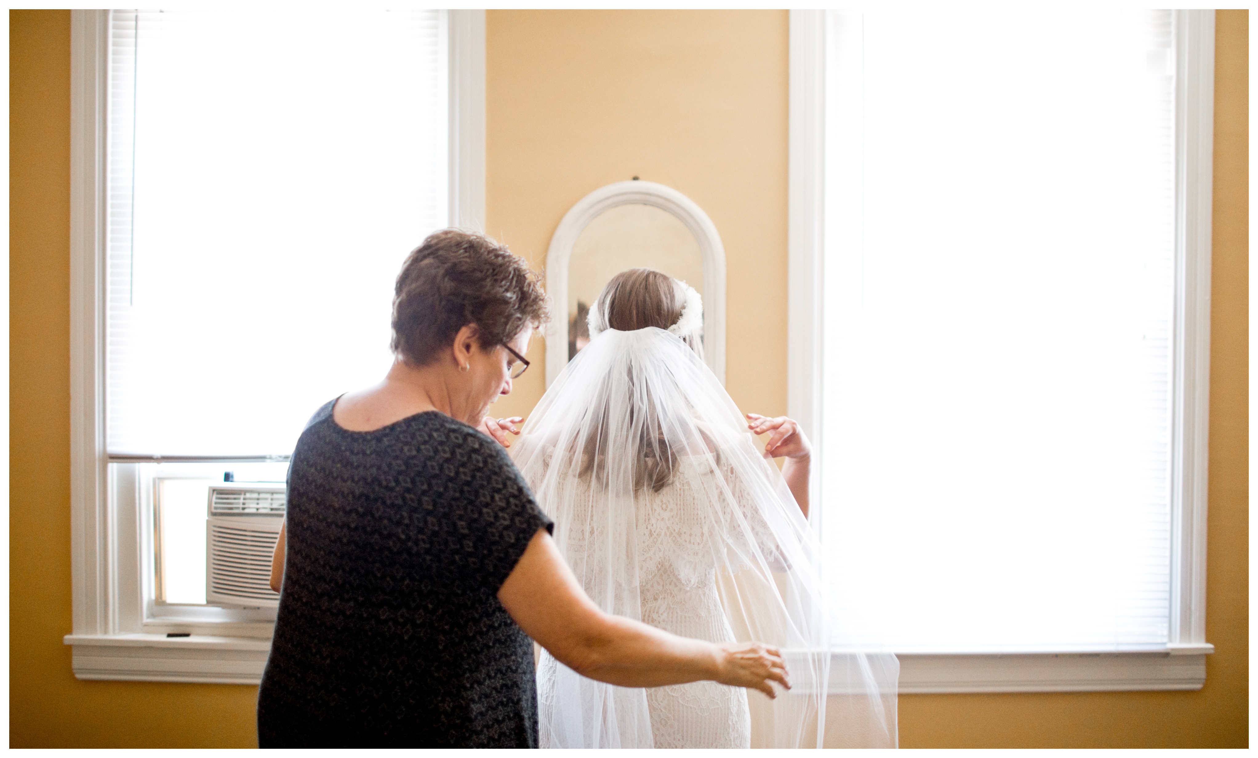 mother of the bride straightening the veil