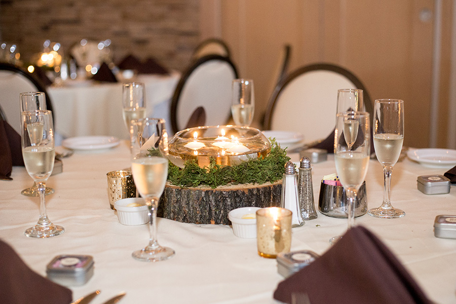 woodland themed wedding reception with moss and wood slice