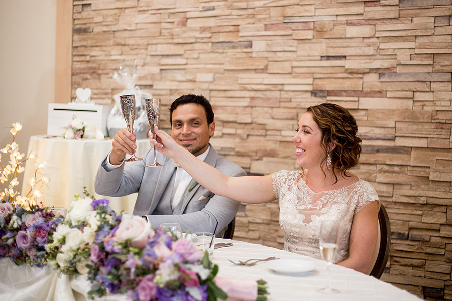 married couple clinks their glasses after toasts