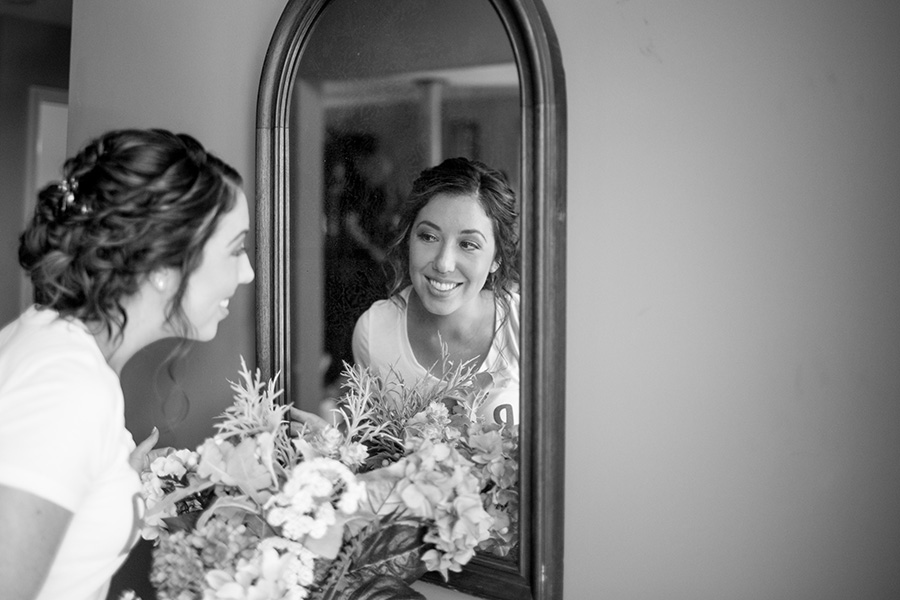 bride looking in the mirror before the wedding