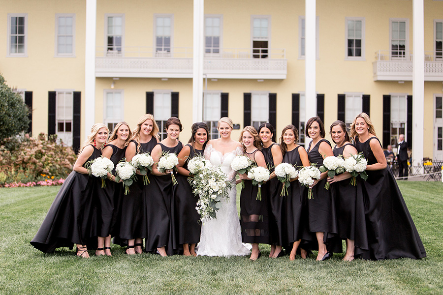 bridesmaids in black with white flowers