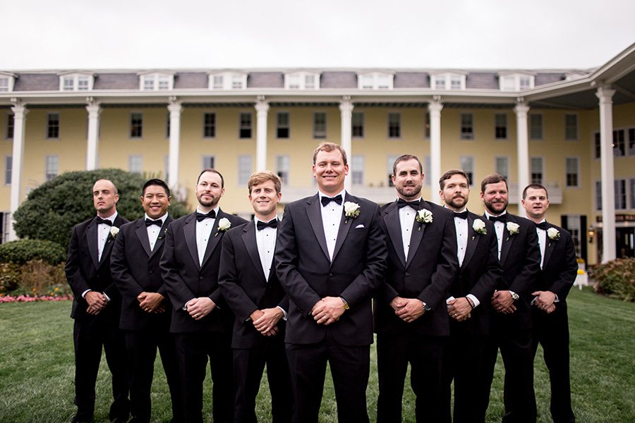 groomsmen in black tuxes at congress hall