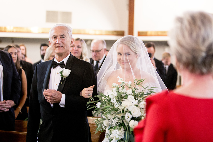 bride walks down the aisle with her dad 
