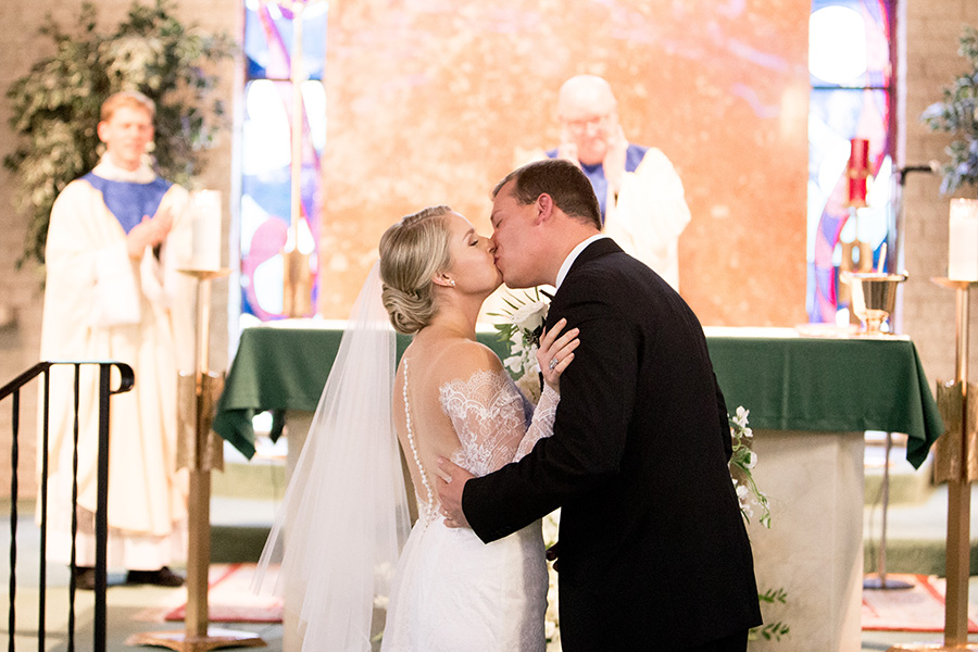 bride and groom share their first kiss in cape may catholic ceremony