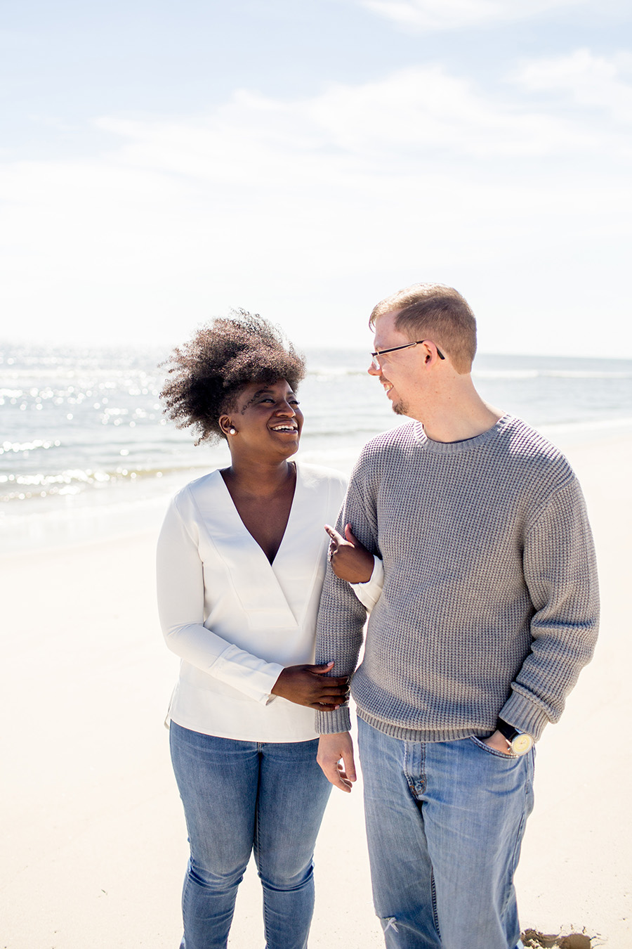 couple pose for a portrait on the beach in LBI