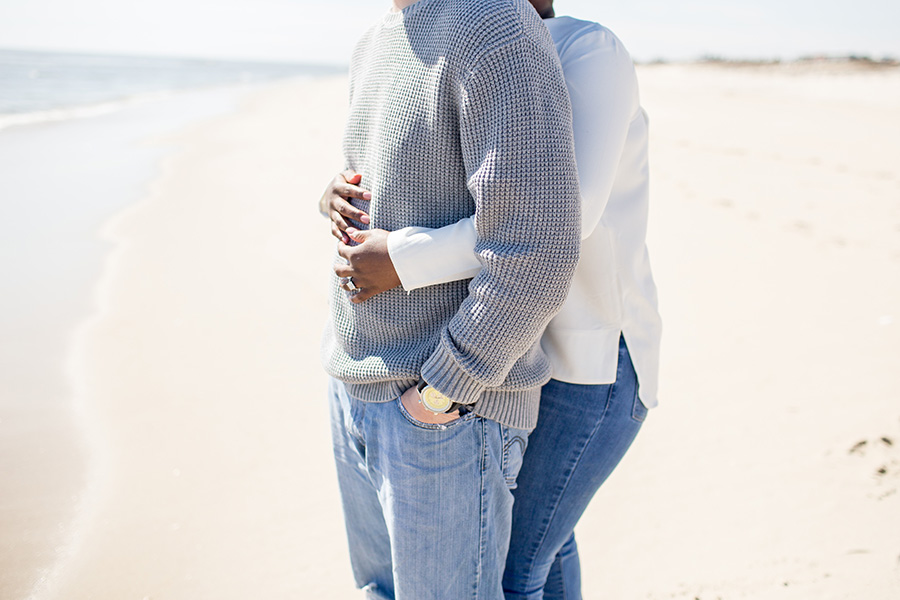 couple give each other a hug on the beach