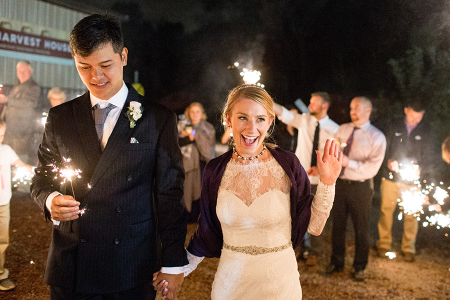 bride and groom have a grand exit with sparklers outside Hill Creek Farms