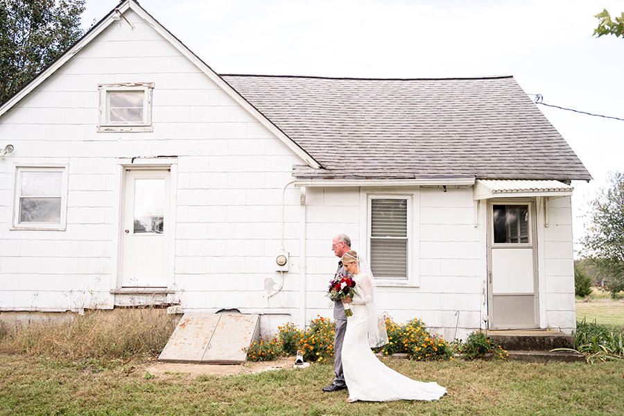 bride walking out of old south jersey farmhouse