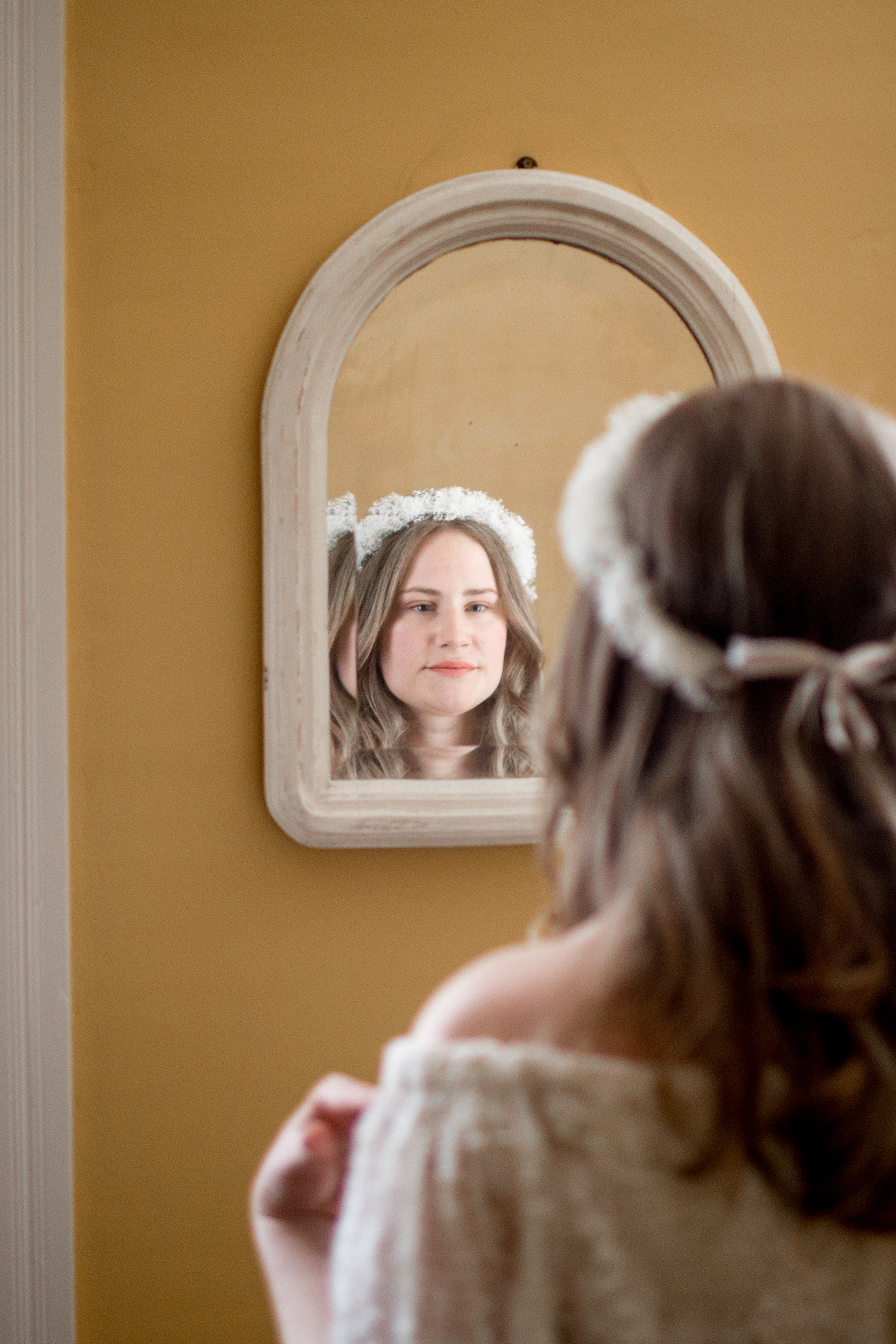 bride gazing in the mirror