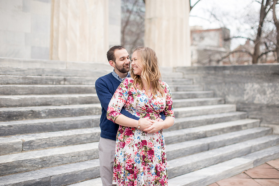 couple poses for their society hill engagement 