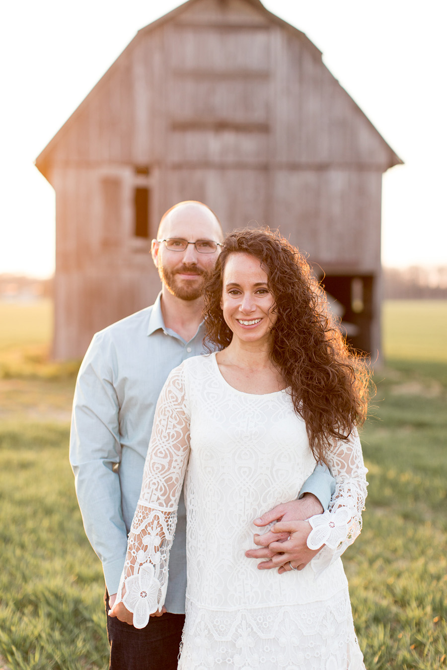 couple in front of their barn
