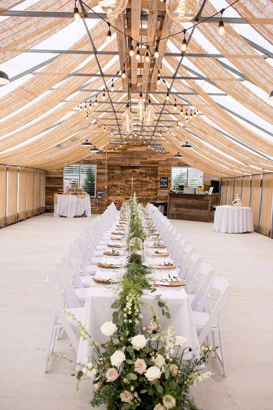 long wedding tables set up in the venue at bast brothers garden center