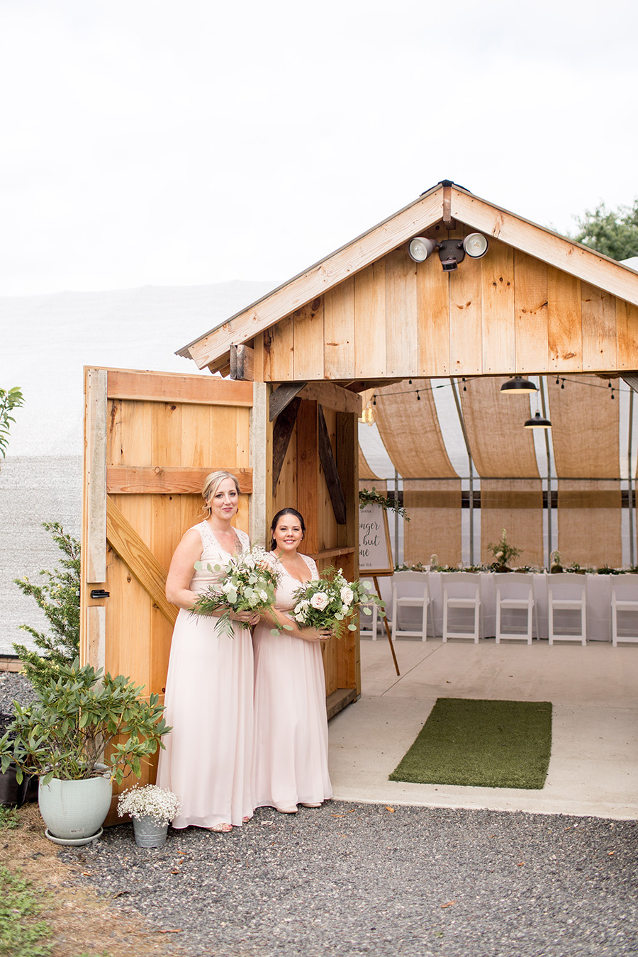 bridesmaids welcome wedding guests into the greenhouse
