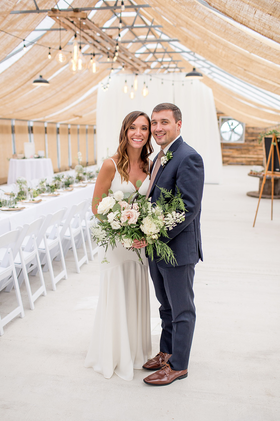 married couple admires wedding decorations inside the greenhouse