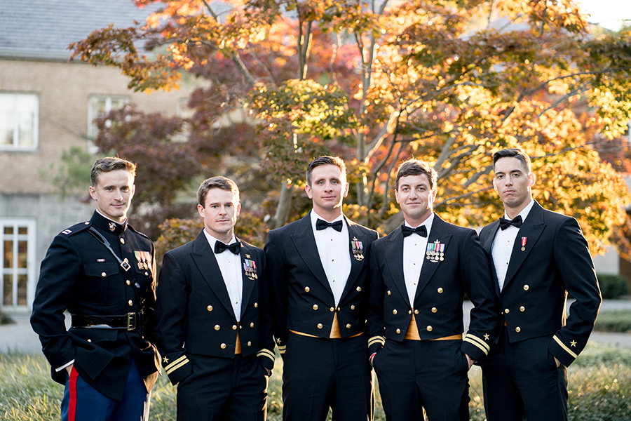 groom and groomsmen pose for pictures outside wedding reception in delaware