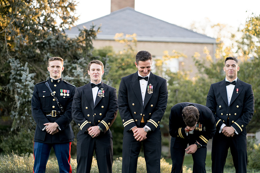 groomsmen laughing together with the groom