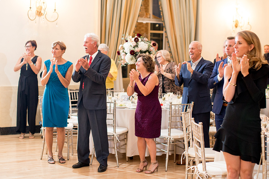 guests cheer for the married couple at the reception