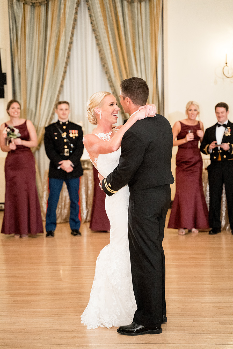 bride and groom share first dance in the ballroom at dupont country club