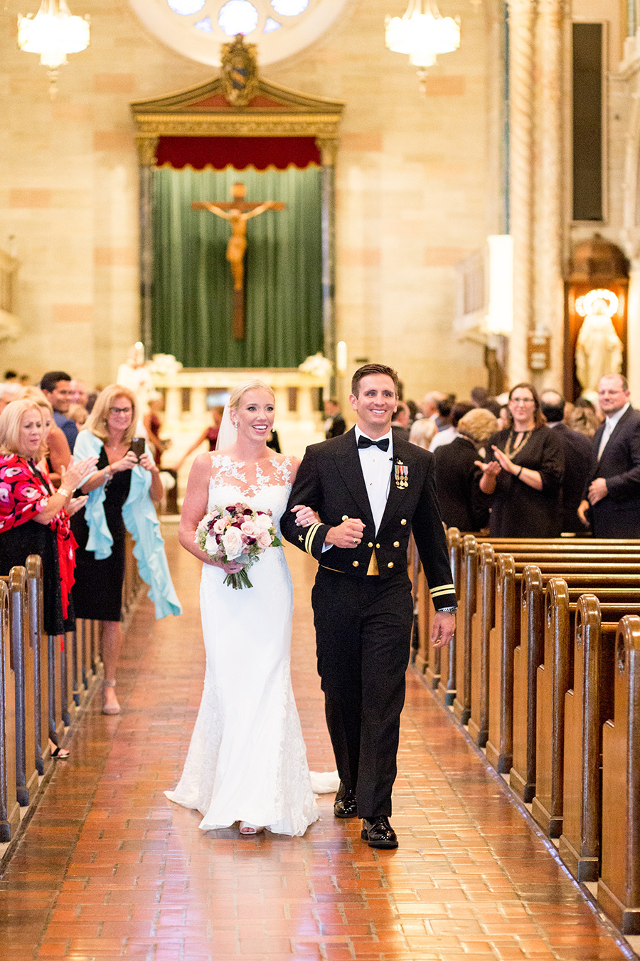 bride and groom walk down the aisle together at st anthony of padua church in wilmington