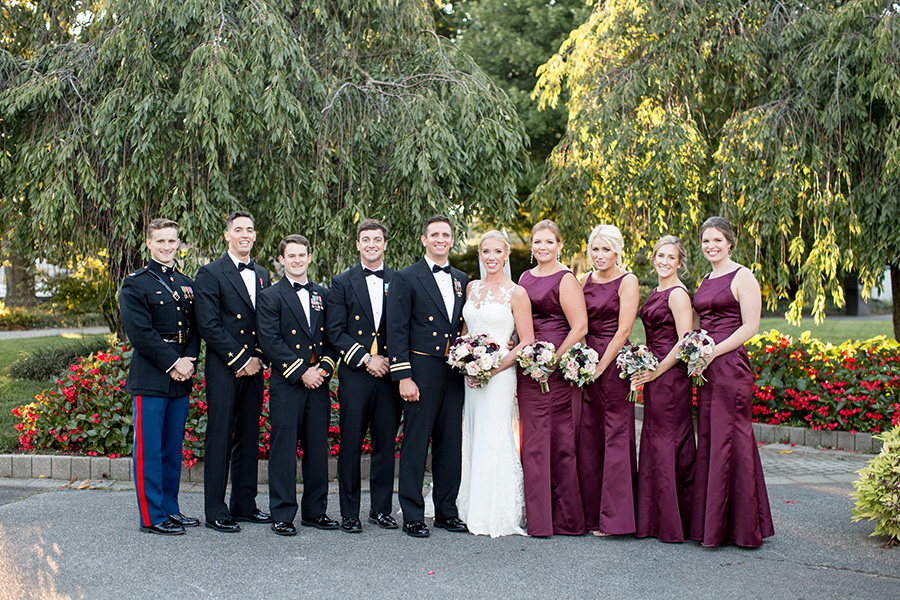 bridemaids and groomsmen stand with the couple at dupont country club wedding in wilmington