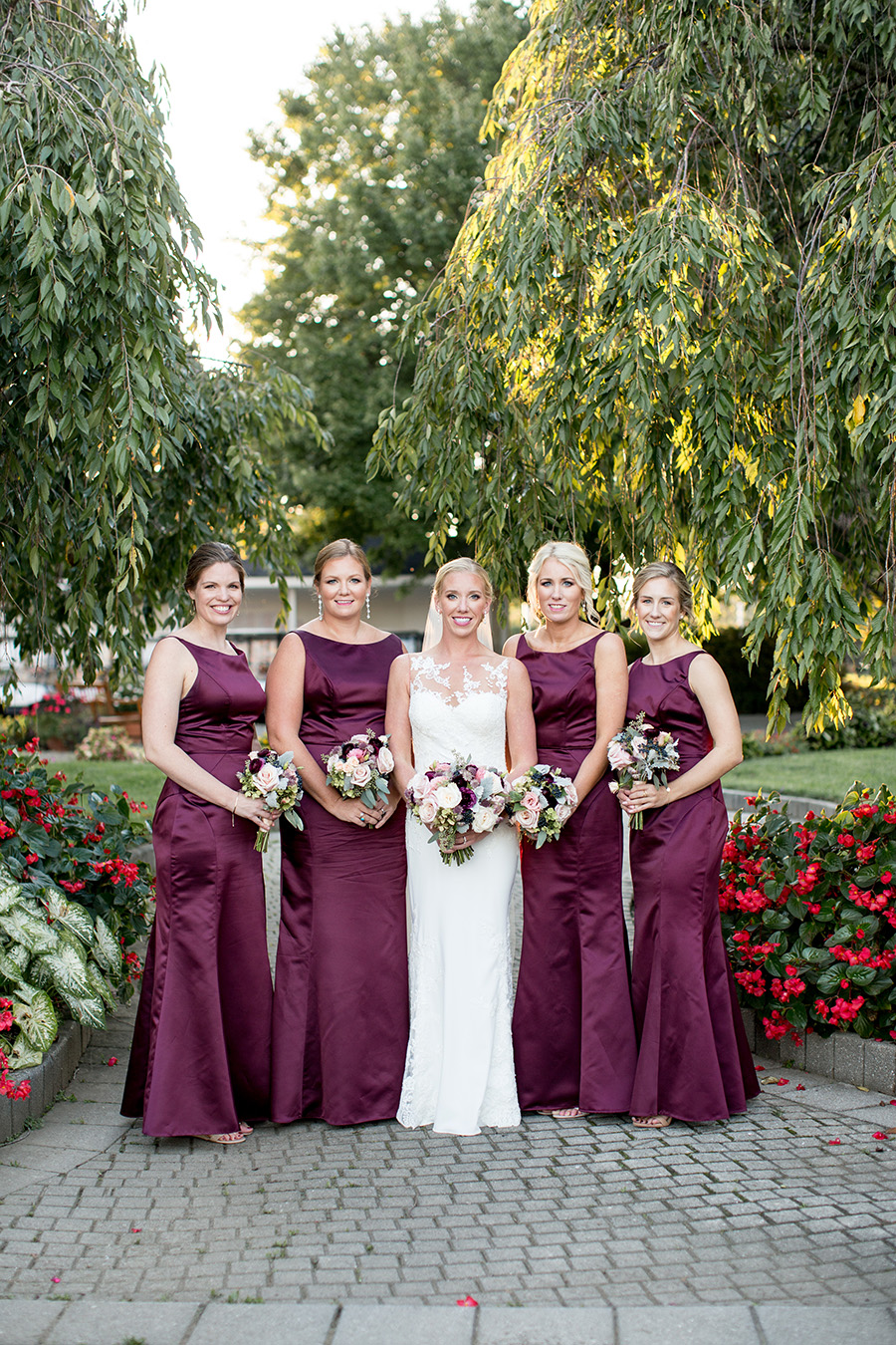 bridesmaids wear floor-length plum gowns 