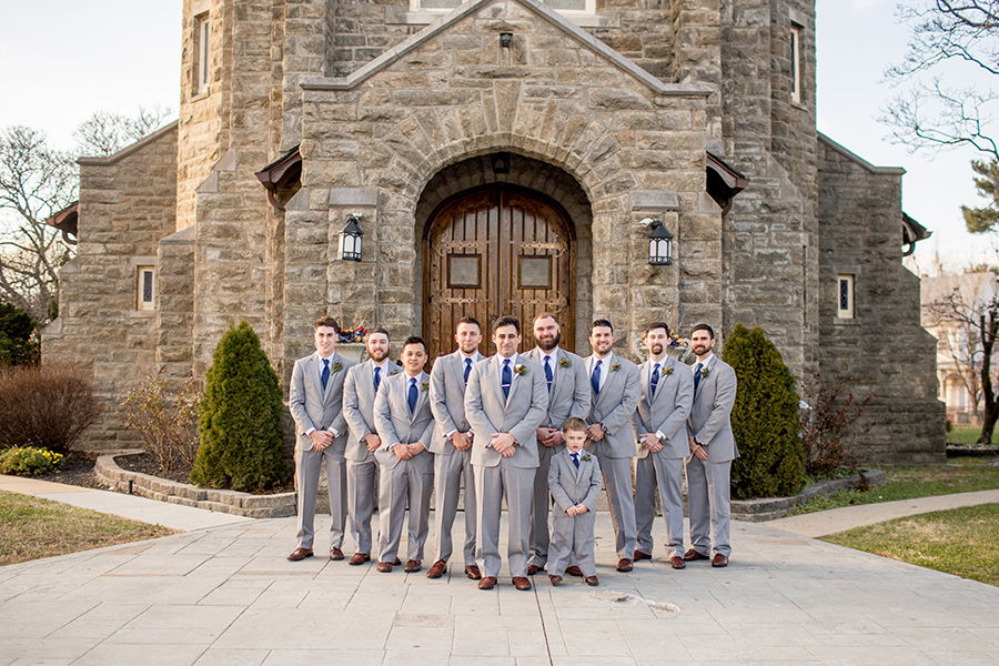 groomsmen together outside immaculate conception church