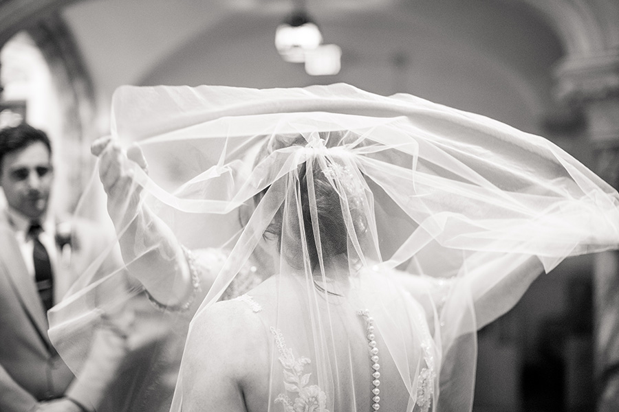 bride wearing veil at her wedding ceremony