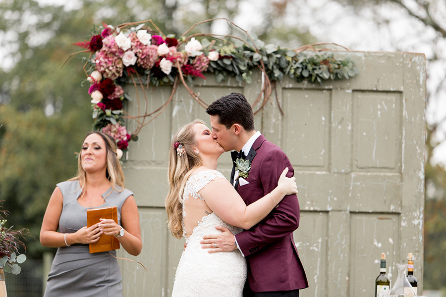 bride and groom share first kiss as a married couple