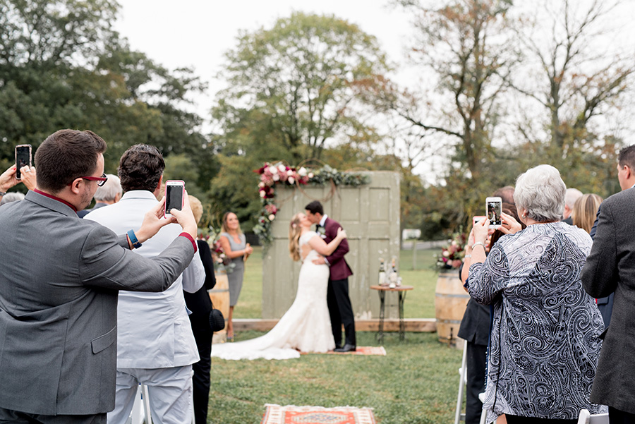guests cheer on the newly married couple at the alpaca farm