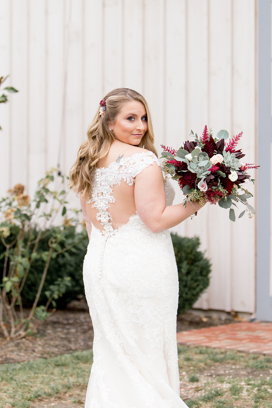 bride wearing lacey dress and waterfall curls