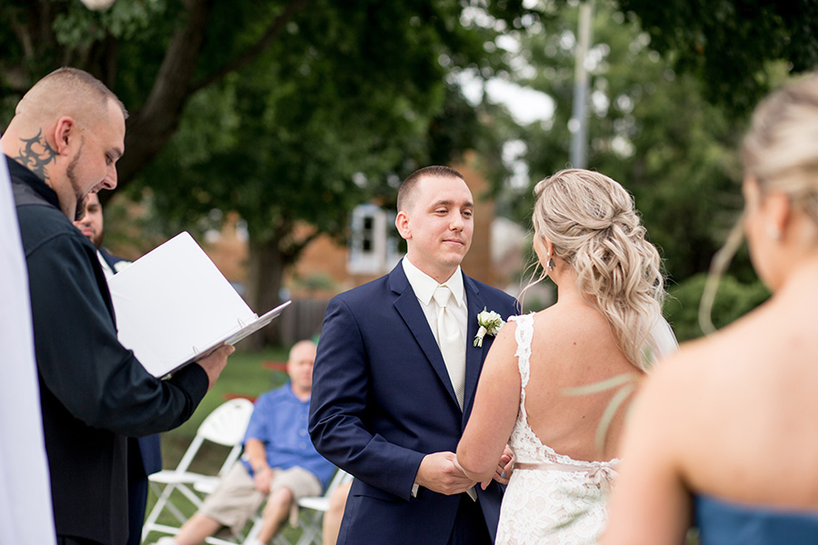 groom says his vows in front of wedding guests