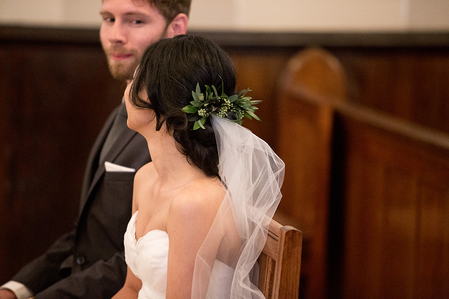 bride wears a floral hair piece