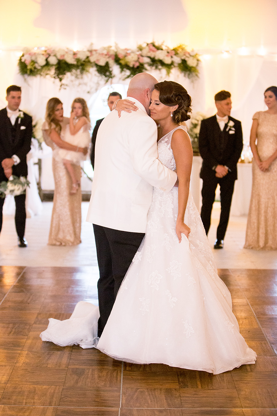 bride and groom share a first dance at their wedding reception on the grounds of Chateau Bu-De