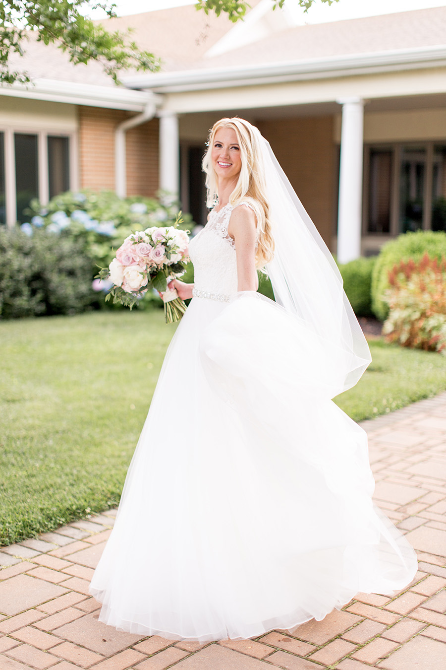 bride shows off her wedding dress