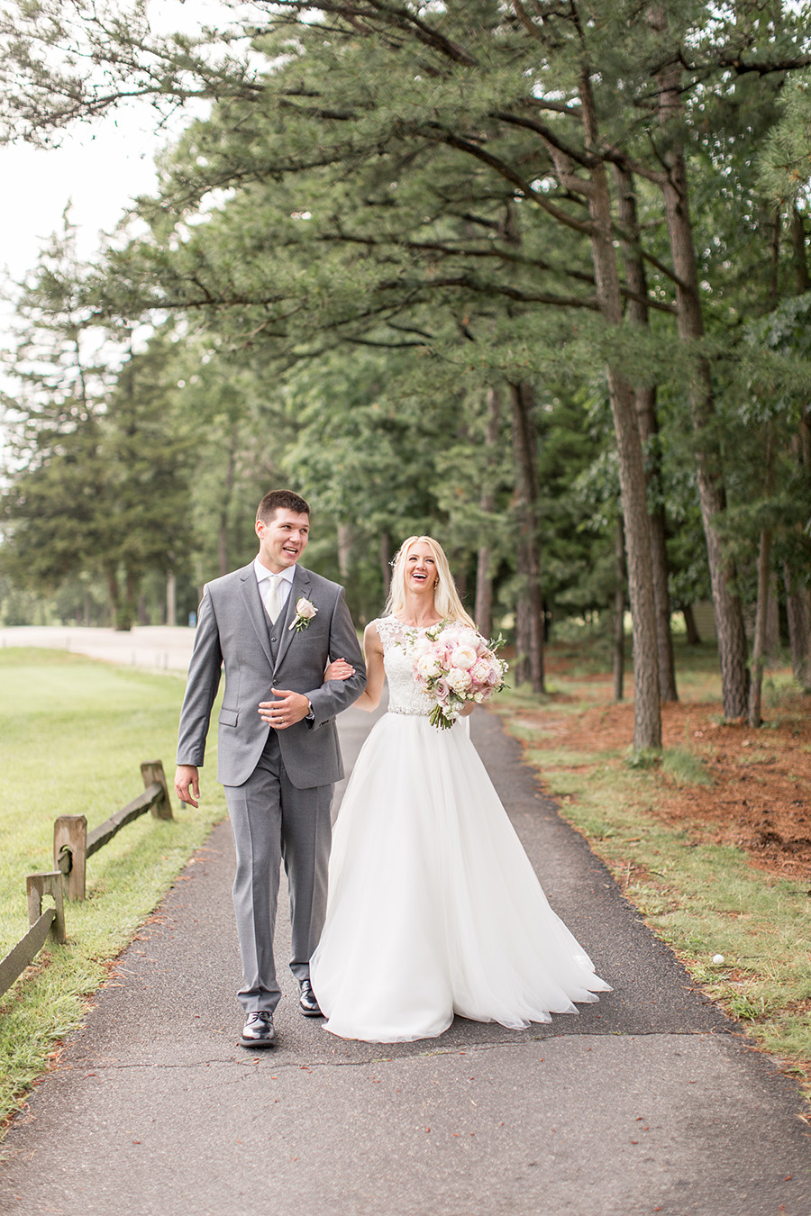 bride and groom walk the grounds at blue heron on their wedding day