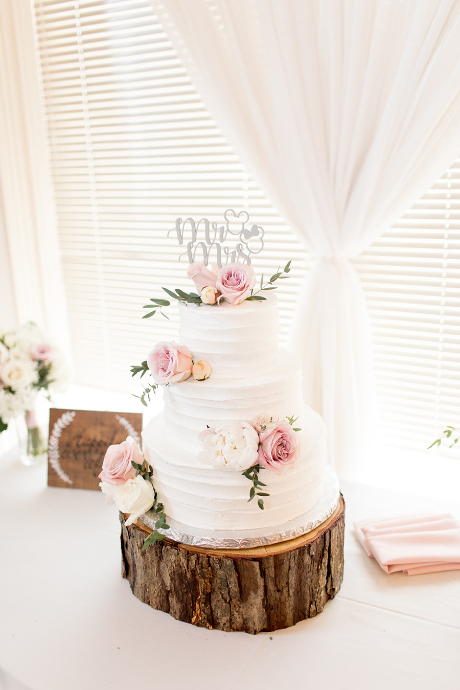 blush roses on wedding cake