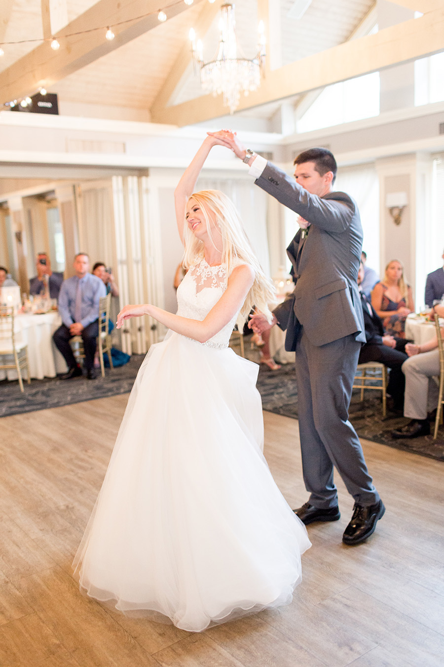couple share a twirl on dance floor