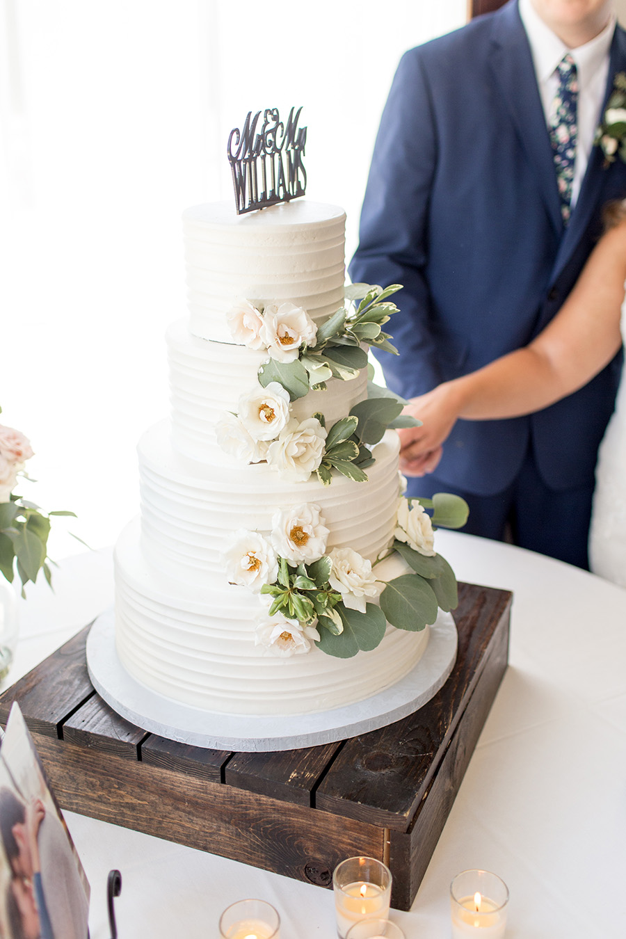 white wedding cake with pastel flowers