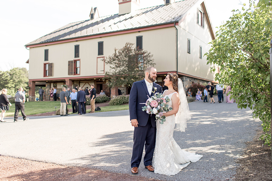 bride and groom in front of the barn at ironstone ranch