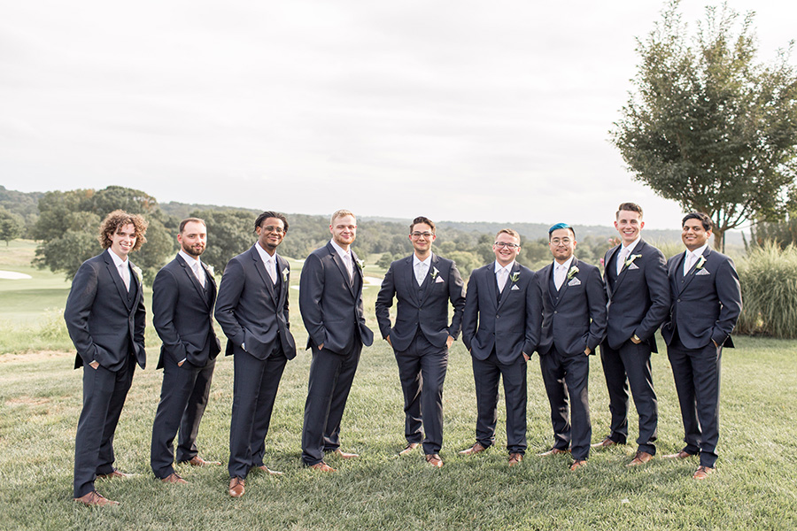 groomsmen in dark gray tuxes