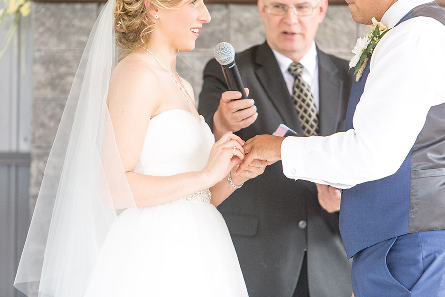 couple exchanging rings during wedding ceremony