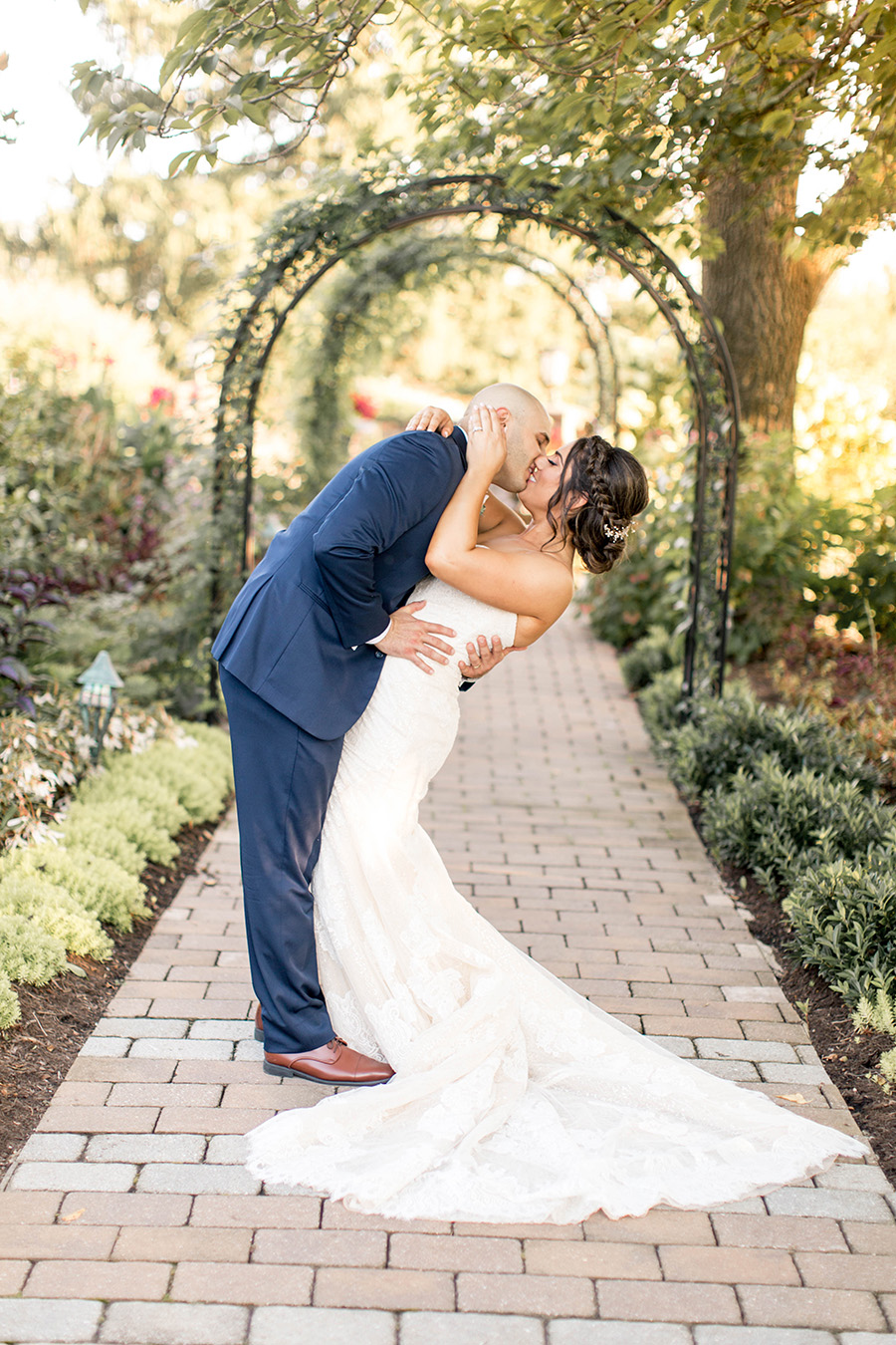bride and groom give each other a kiss at penn oaks golf club