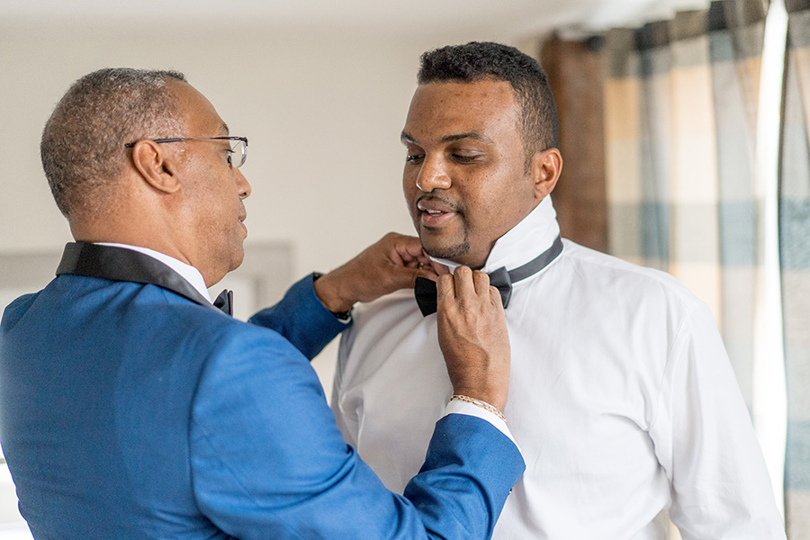 Groom's father getting ready before wedding