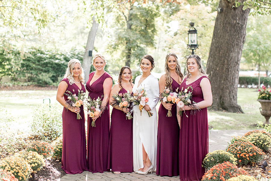 bridesmaids in autumn colored floor length dresses