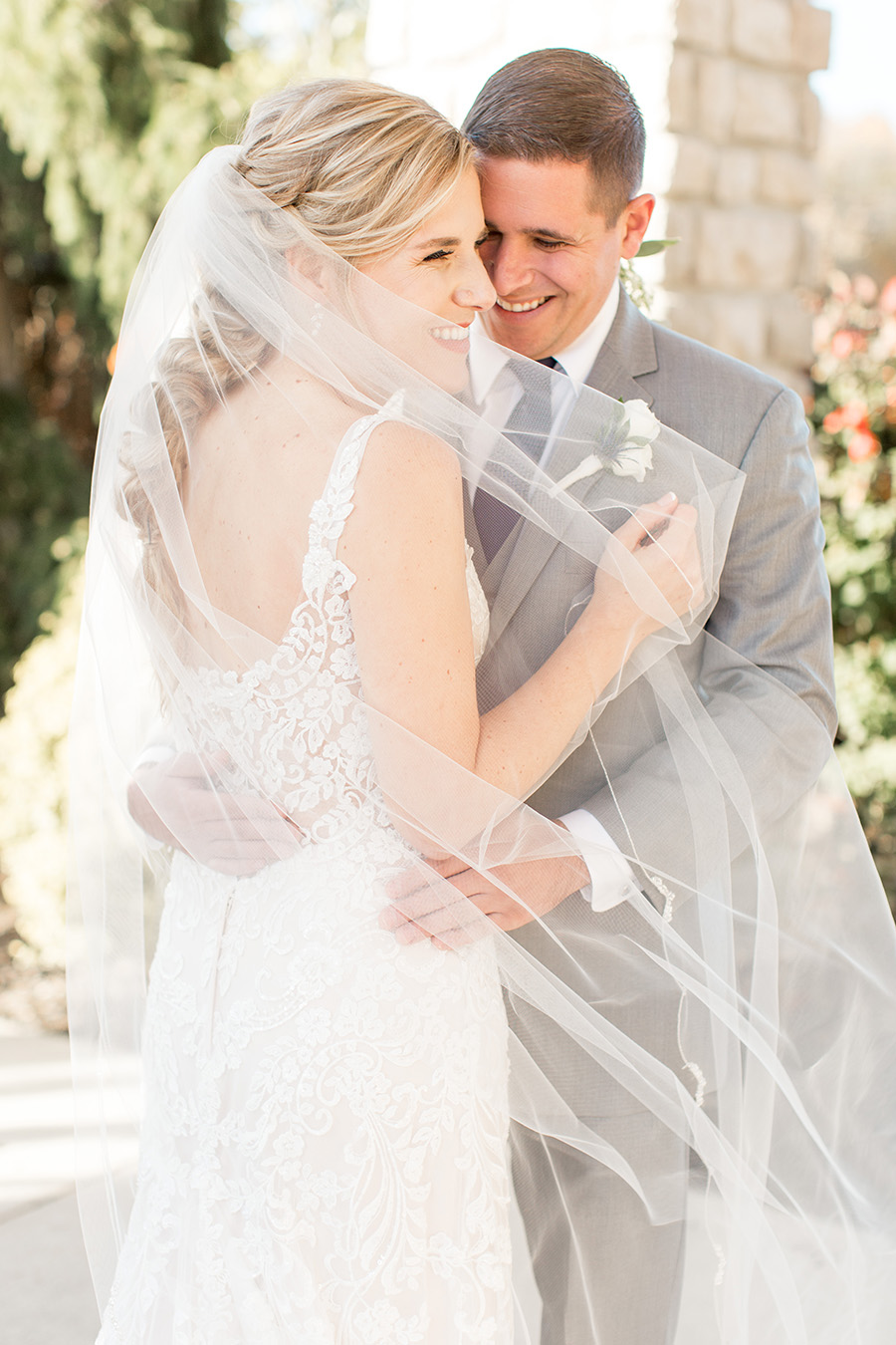 bride in lace open-backed gown and messy braid