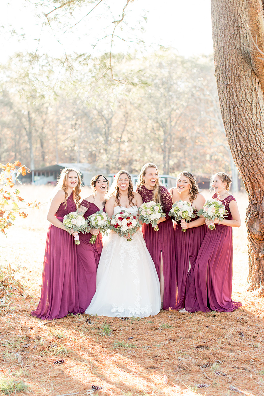 bridesmaids in floor length plum dresses 